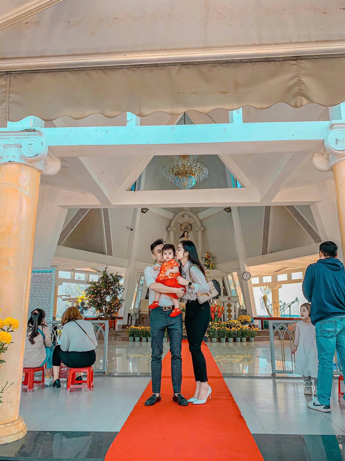 Trang Teresa and her husband with their daughter at church
